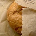 Partial view of a bread roll wrapped in a beeusable beeswax bread wrap.