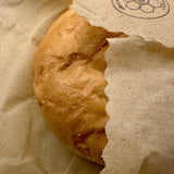 Partial view of a bread roll wrapped in a beeusable beeswax bread wrap.