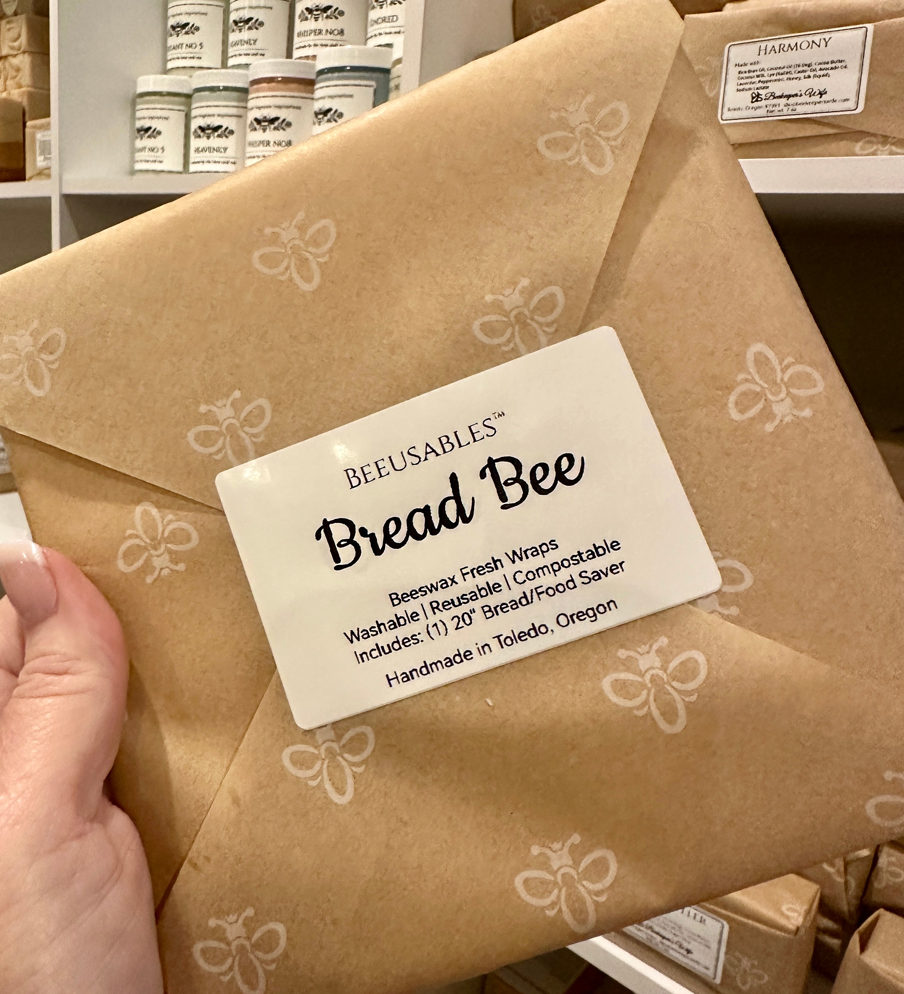 Bread Bee wrap packaging with a visible label held by a hand in a store setting.