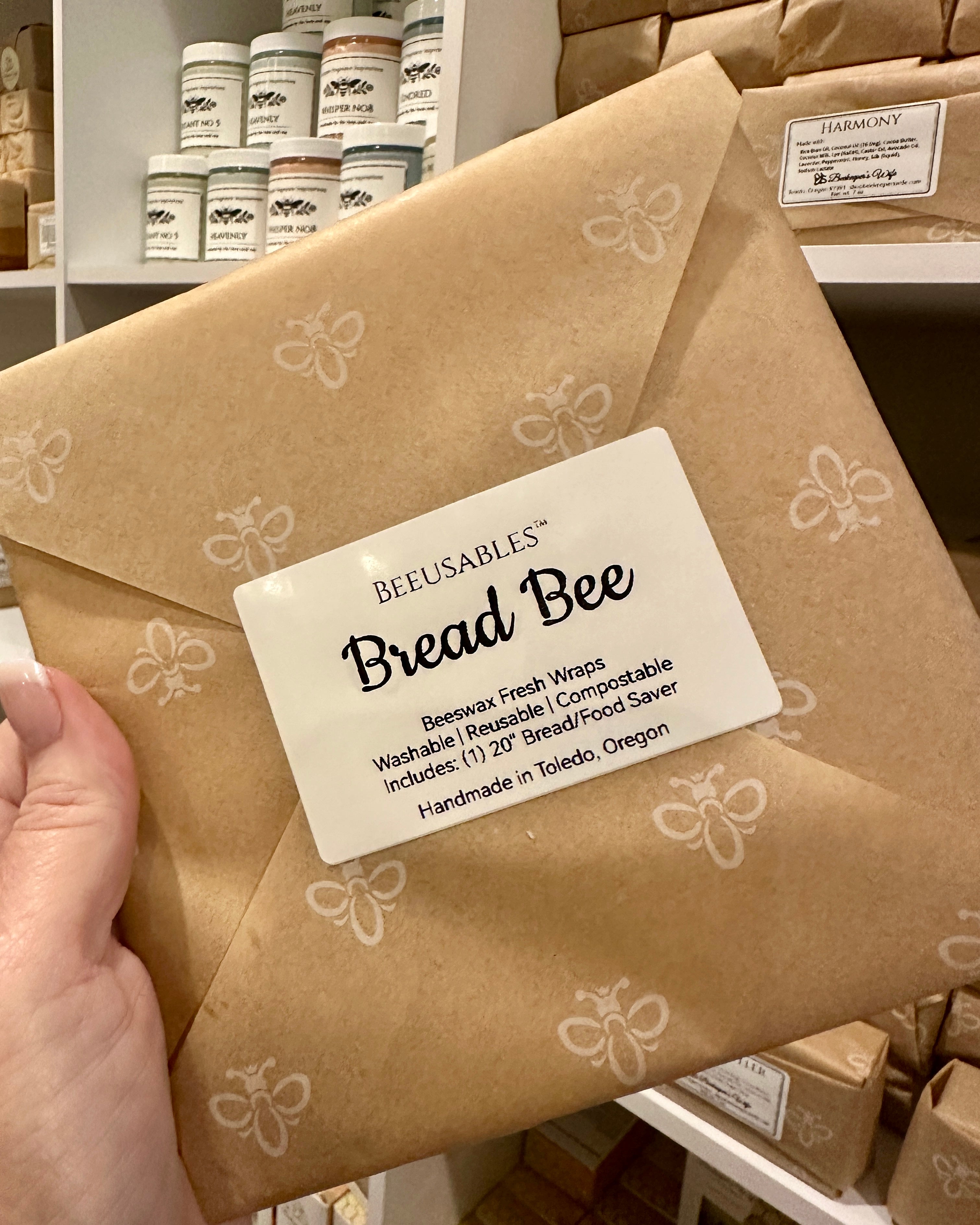 Bread Bee wrap packaging with a visible label held by a hand in a store setting.