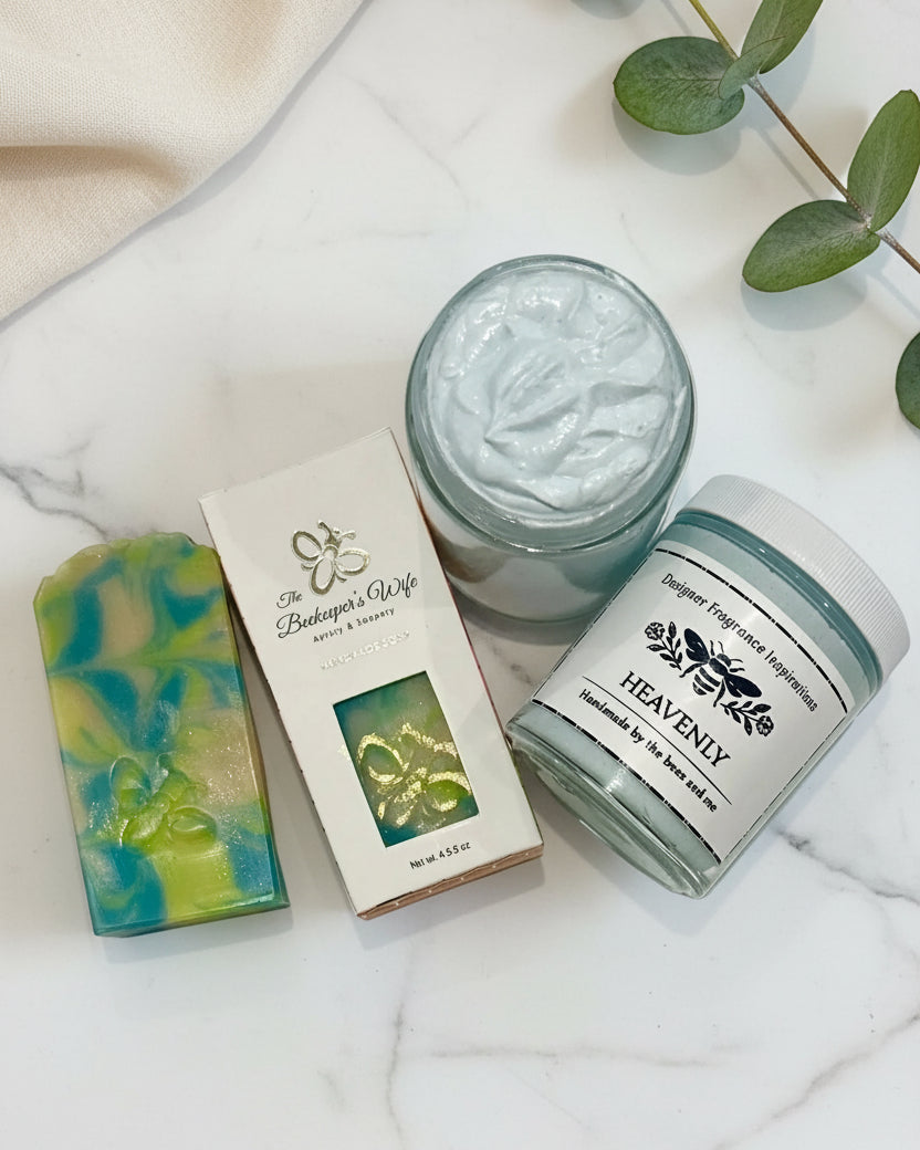 Three beauty products including a jar of cream, a bar of soap, and a container labeled 'Heavenly' on a white background.