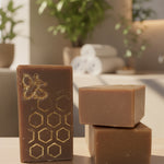 Three bars of soap with a honeycomb design on a kitchen counter.