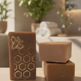Three bars of soap with a honeycomb design on a kitchen counter.