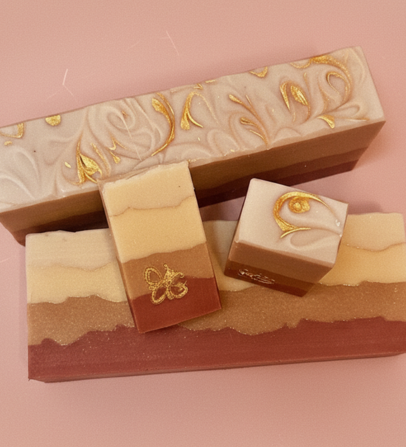 Three layered soap bars with decorative designs on a pink background