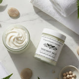 Two jars of light golden whipped body butter, one open, showing the contents 